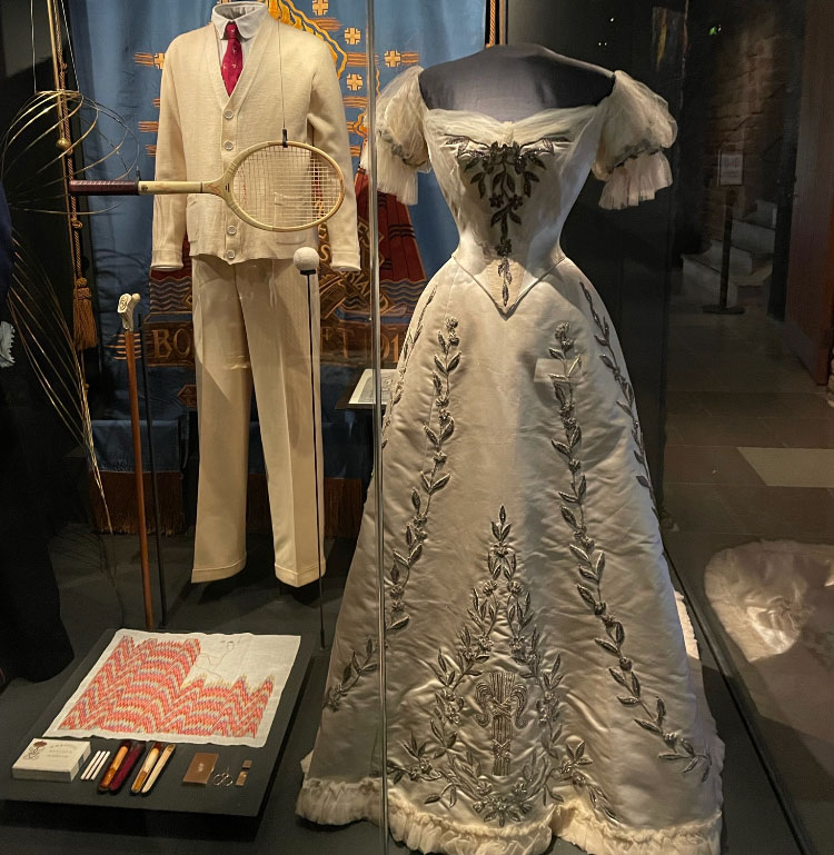 A white ceremonial gown and men's tennis suit.